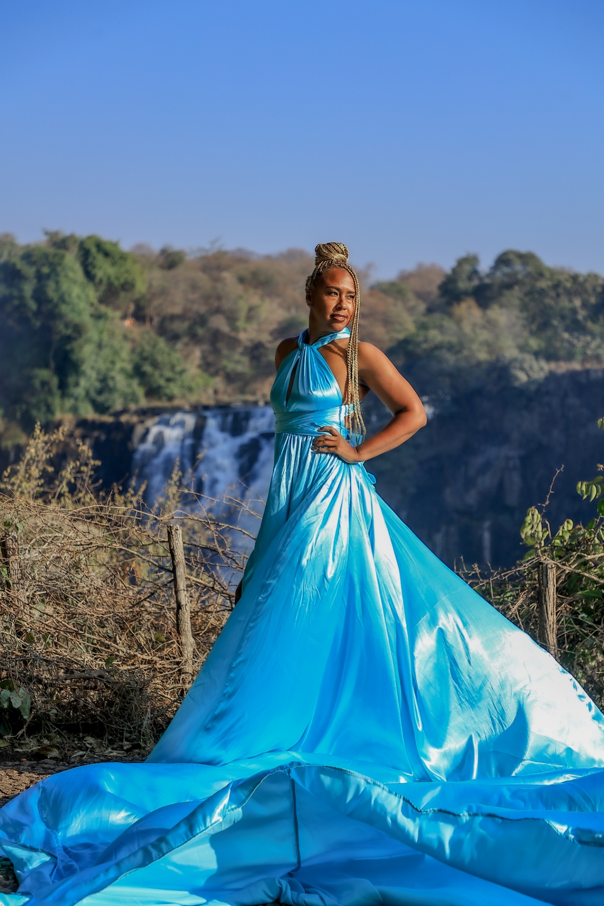 Turquoise satin flying dress with Victoria Falls in the background