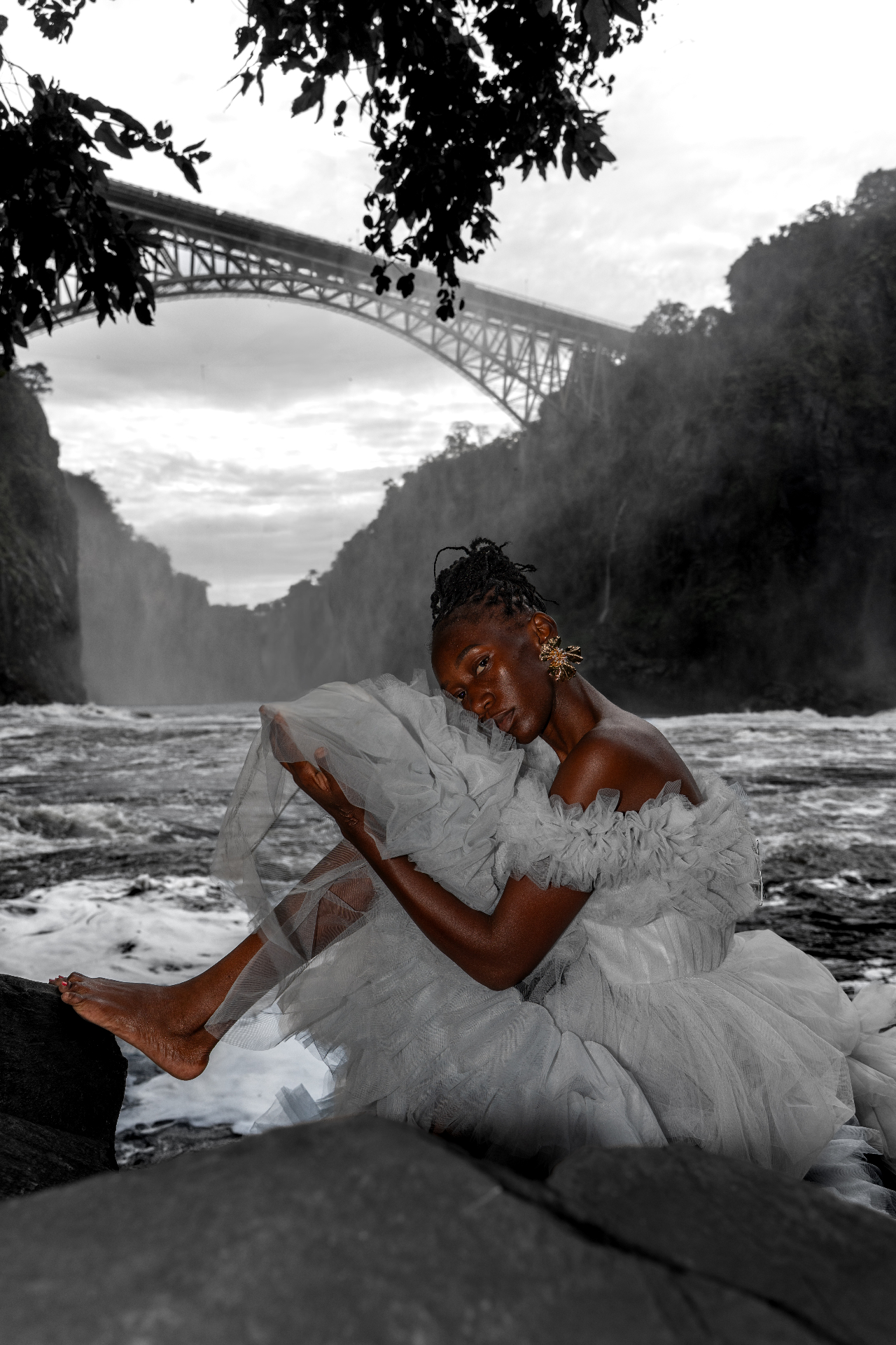 White tulle gown on the rocks beneath the Victoria Falls Bridge
