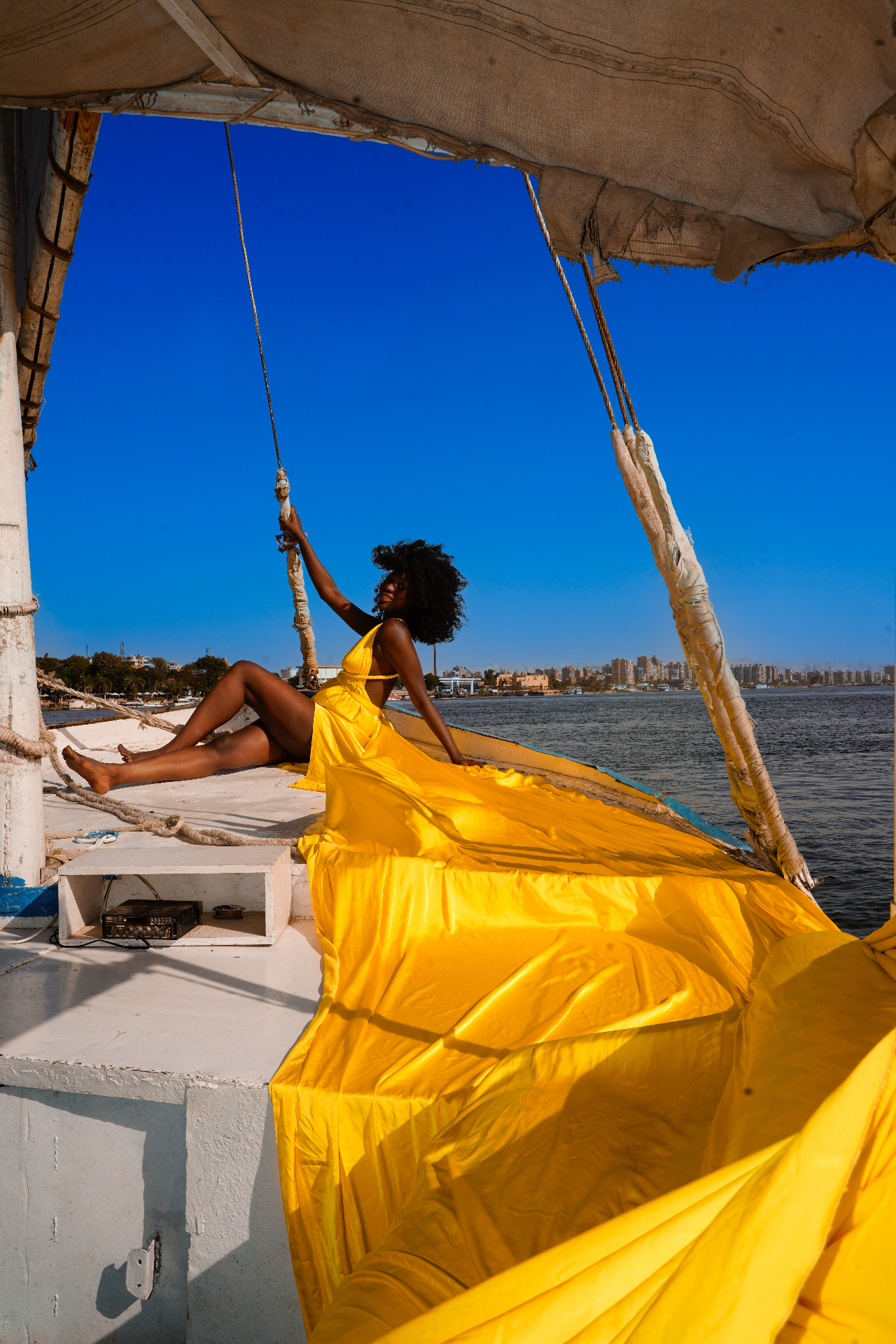 Yellow flying dress spread across the deck of a felucca on the Nile