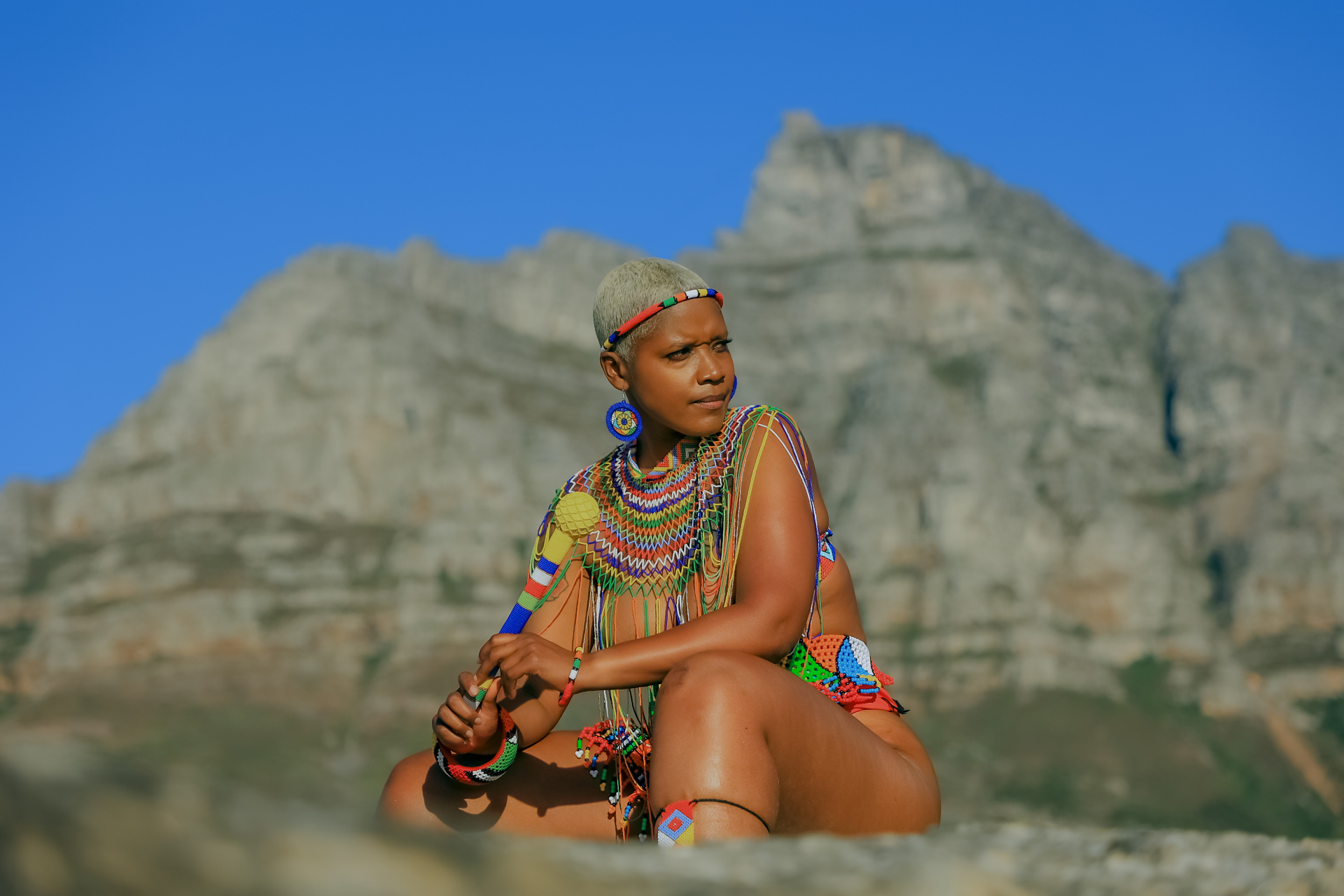 Portrait in colourful beaded styling against the Cape Town mountains